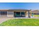 Inviting covered patio featuring a dining area and well-maintained lawn at 18159 W Piro St, Goodyear, AZ 85338