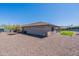 Expansive backyard featuring desert landscaping and a covered patio area at 18159 W Piro St, Goodyear, AZ 85338