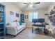 Cozy bedroom setup as a home office, featuring a comfortable couch and an efficient workspace at 18159 W Piro St, Goodyear, AZ 85338