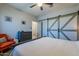 Serene bedroom with a comfortable bed, barn-style closet doors, and stylish decor at 18159 W Piro St, Goodyear, AZ 85338