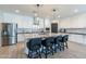 Spacious kitchen with a large island, stainless steel appliances, pendant lighting, and ample counter space at 18159 W Piro St, Goodyear, AZ 85338