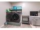 Well-equipped laundry room featuring modern washer, dryer, and practical storage solutions at 18159 W Piro St, Goodyear, AZ 85338