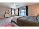 The main bedroom offers a spacious design with a sitting area, dresser, and large windows that let in plenty of light at 18159 W Piro St, Goodyear, AZ 85338