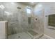 This walk-in shower includes a built-in seat and modern tile at 18159 W Piro St, Goodyear, AZ 85338