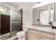 Bathroom featuring a granite-topped vanity, framed mirror and a shower with glass doors at 1818 S Toltec --, Mesa, AZ 85204