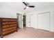 Cozy bedroom featuring tiled flooring, a ceiling fan, and access to an en suite bathroom at 1818 S Toltec --, Mesa, AZ 85204