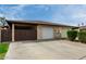 Charming townhome with single-car garage and low maintenance desert landscaping under a sunny blue sky at 1818 S Toltec --, Mesa, AZ 85204