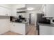 Well-lit kitchen area with white cabinets, tiled flooring, and an open layout for modern living at 1818 S Toltec --, Mesa, AZ 85204