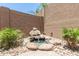 A charming backyard fountain with rock accents, adding a peaceful touch to the outdoor space at 18956 W Laurel Ln, Surprise, AZ 85388