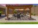 Backyard oasis featuring a cozy covered patio, lush landscaping and room to entertain at 18956 W Laurel Ln, Surprise, AZ 85388