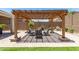 Beautiful backyard patio featuring a pergola with outdoor seating, a perfect space for entertaining guests and enjoying the outdoors at 18956 W Laurel Ln, Surprise, AZ 85388