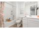 This bright bathroom features neutral walls, a shower-tub combo, a single sink vanity, and tile floors at 18956 W Laurel Ln, Surprise, AZ 85388