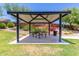 A shaded picnic area in a community park, surrounded by vibrant flowers and greenery at 18956 W Laurel Ln, Surprise, AZ 85388