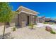Inviting front exterior showcasing desert landscaping, a charming porch, and a spacious driveway at 18956 W Laurel Ln, Surprise, AZ 85388