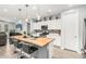 This kitchen features a butcher block island, sleek white cabinetry, and stainless steel appliances at 18956 W Laurel Ln, Surprise, AZ 85388