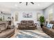 Comfortable living room features neutral colors, a ceiling fan, and cozy furniture at 18956 W Laurel Ln, Surprise, AZ 85388