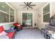 A covered patio with brick pavers, overhead fan, seating, and views of the back yard at 18956 W Laurel Ln, Surprise, AZ 85388