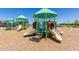 Bright and colorful community playground featuring slides, climbing structures, and ample play space at 18956 W Laurel Ln, Surprise, AZ 85388