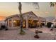 Back exterior of home with covered patio, manicured landscaping, and gravel for easy maintenance at 2123 S Bristol Dr, Mesa, AZ 85209