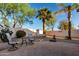 The backyard offers pavers, desert landscaping, and a relaxing swing, all in a private setting at 2123 S Bristol Dr, Mesa, AZ 85209