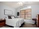 Cozy bedroom featuring a comfortable bed, natural light, and decorative wall art at 2123 S Bristol Dr, Mesa, AZ 85209