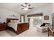 Spacious bedroom with ceiling fan, sitting area, and sliding glass doors to the patio at 2123 S Bristol Dr, Mesa, AZ 85209