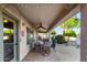 Inviting covered patio with ceiling fan, brick pavers, and string lights for outdoor enjoyment at 2123 S Bristol Dr, Mesa, AZ 85209