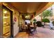 Relaxing covered patio with brick pavers, outdoor seating, ceiling fan, and festive string lights at 2123 S Bristol Dr, Mesa, AZ 85209