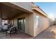 Covered patio featuring brick pavers, cozy seating, and a view of the spacious, low-maintenance yard at 2123 S Bristol Dr, Mesa, AZ 85209