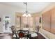 Bright dining area with elegant seating, bay windows, and hardwood flooring at 2123 S Bristol Dr, Mesa, AZ 85209