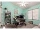 Bright home office with mint walls, a glass desk, stylish decor, and plenty of natural light at 2123 S Bristol Dr, Mesa, AZ 85209
