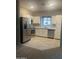 Well-lit kitchen with stainless steel appliances, white cabinets, and modern tiled flooring at 2244 W Laurie Ln, Phoenix, AZ 85021