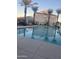 Community pool surrounded by palm trees and residential buildings at 2244 W Laurie Ln, Phoenix, AZ 85021