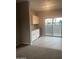 Bright wet bar adjacent to a dining area, featuring granite counters and a stainless steel beverage cooler at 2244 W Laurie Ln, Phoenix, AZ 85021