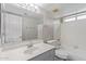 Bright bathroom with a tub and shower combination, modern fixtures, and white tiled walls at 2257 E Lockwood St, Mesa, AZ 85213