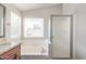 Bathroom featuring a shower, garden tub, and window at 2257 E Lockwood St, Mesa, AZ 85213