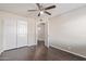 Bedroom featuring wood-look floors, ceiling fan, closet and interior door at 2257 E Lockwood St, Mesa, AZ 85213