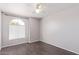 Bedroom with wood-look floors, a ceiling fan, and an arched window at 2257 E Lockwood St, Mesa, AZ 85213