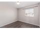 Neutral bedroom with wood-look floors, ceiling fan, and a window with a neighborhood view at 2257 E Lockwood St, Mesa, AZ 85213