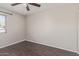 Bedroom with wood-look floors, ceiling fan, and window with exterior views at 2257 E Lockwood St, Mesa, AZ 85213