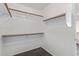 Walk-in closet with built-in shelving and hardwood floors at 2257 E Lockwood St, Mesa, AZ 85213