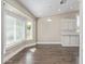 Cozy dining area featuring dark wood floors, bright windows, and modern light fixture at 2257 E Lockwood St, Mesa, AZ 85213