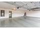 This spacious garage has a clean epoxy floor and automatic door, offering convenience and functionality at 2257 E Lockwood St, Mesa, AZ 85213