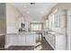 Gourmet kitchen with white cabinets, granite countertops, stainless appliances, and dark wood floors at 2257 E Lockwood St, Mesa, AZ 85213