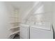 A clean and well-organized laundry room with white shelves and modern washer and dryer units at 2257 E Lockwood St, Mesa, AZ 85213