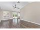 Spacious living room featuring dark wood floors, bright windows, and neutral walls at 2257 E Lockwood St, Mesa, AZ 85213