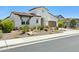 Charming single-Gathering home with a well-kept xeriscaped front yard, neutral tones, and a two-car garage at 22743 N 97Th Dr, Peoria, AZ 85383