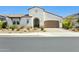 Beautiful single-Gathering home with a well-maintained xeriscaped front yard and an attached two-car garage at 22743 N 97Th Dr, Peoria, AZ 85383