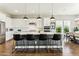 Bright and airy kitchen with a large center island, pendant lighting, and stainless steel appliances at 22743 N 97Th Dr, Peoria, AZ 85383