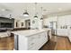Modern kitchen with a large island, white cabinetry, stainless steel appliances, and open layout at 22743 N 97Th Dr, Peoria, AZ 85383